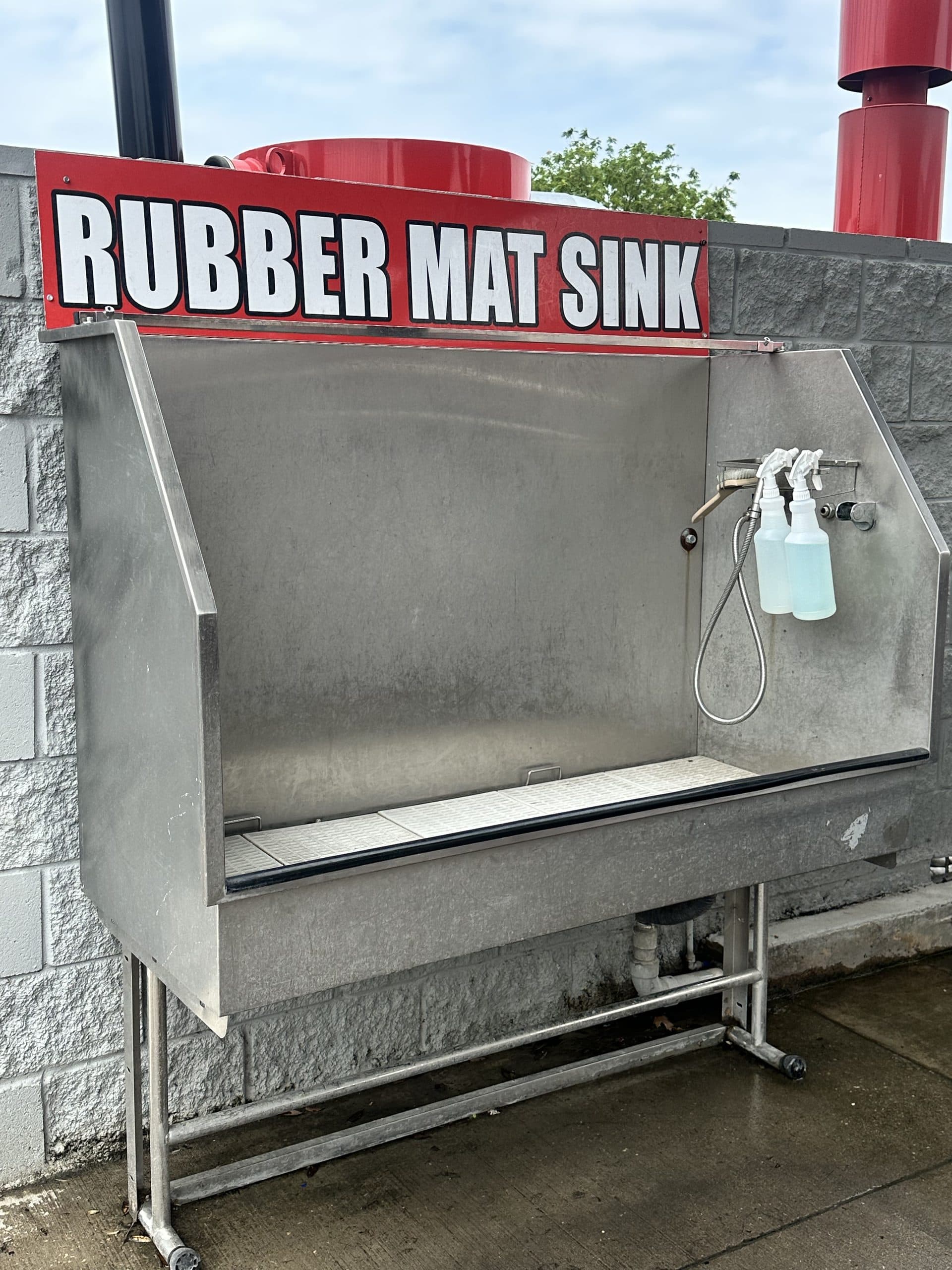 Self-serve rubber mat cleaning sink