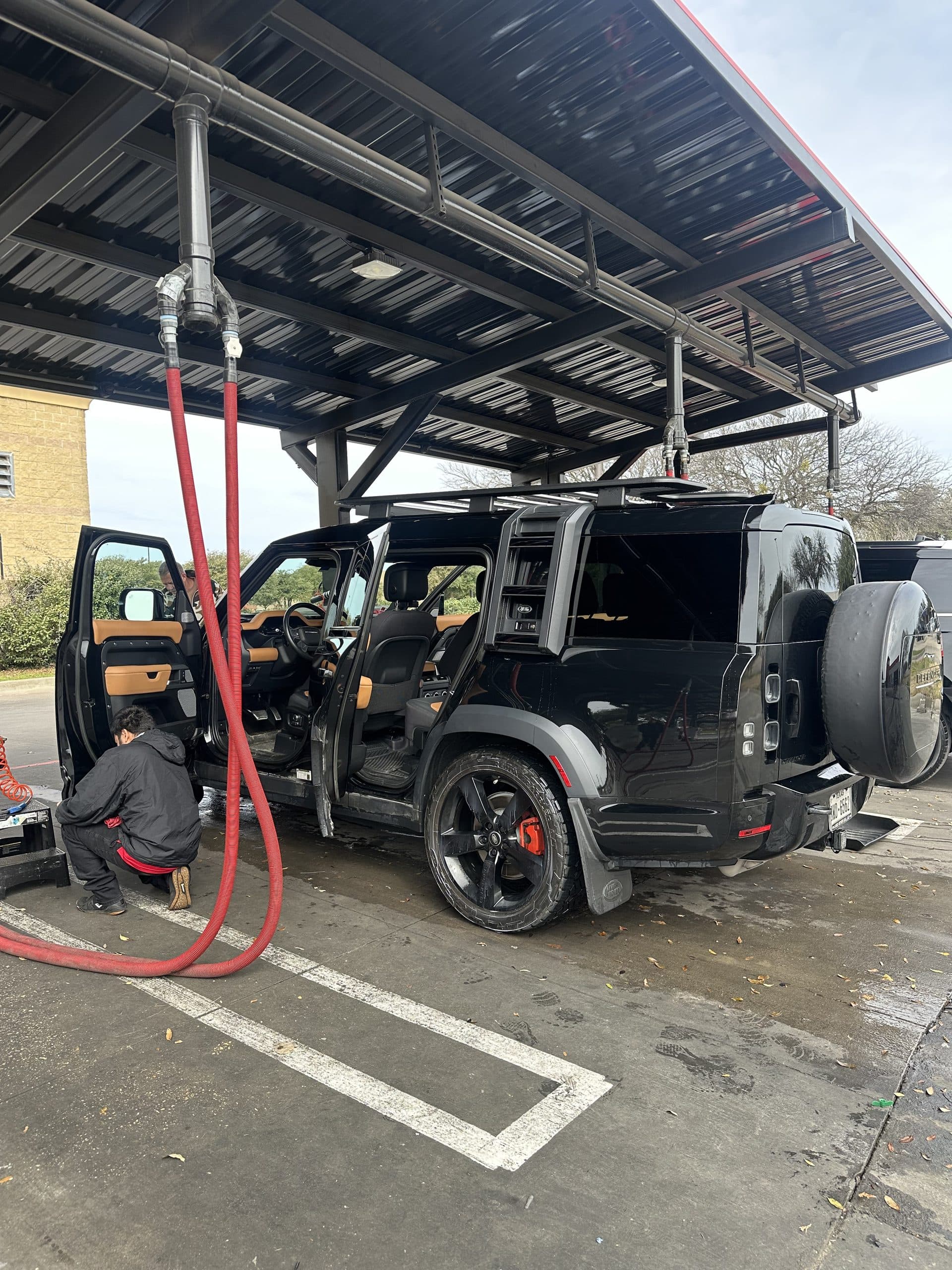 Detailing a Land Rover Defender at the vacuum canopy