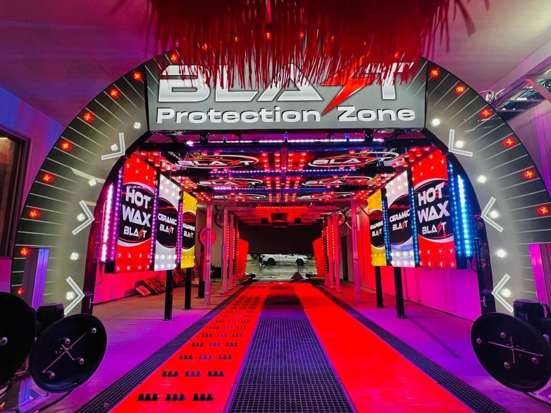 The Blast Protection Zone wash tunnel lit in red — Hot Wax, Ceramic Blast and Graphene Blast arches