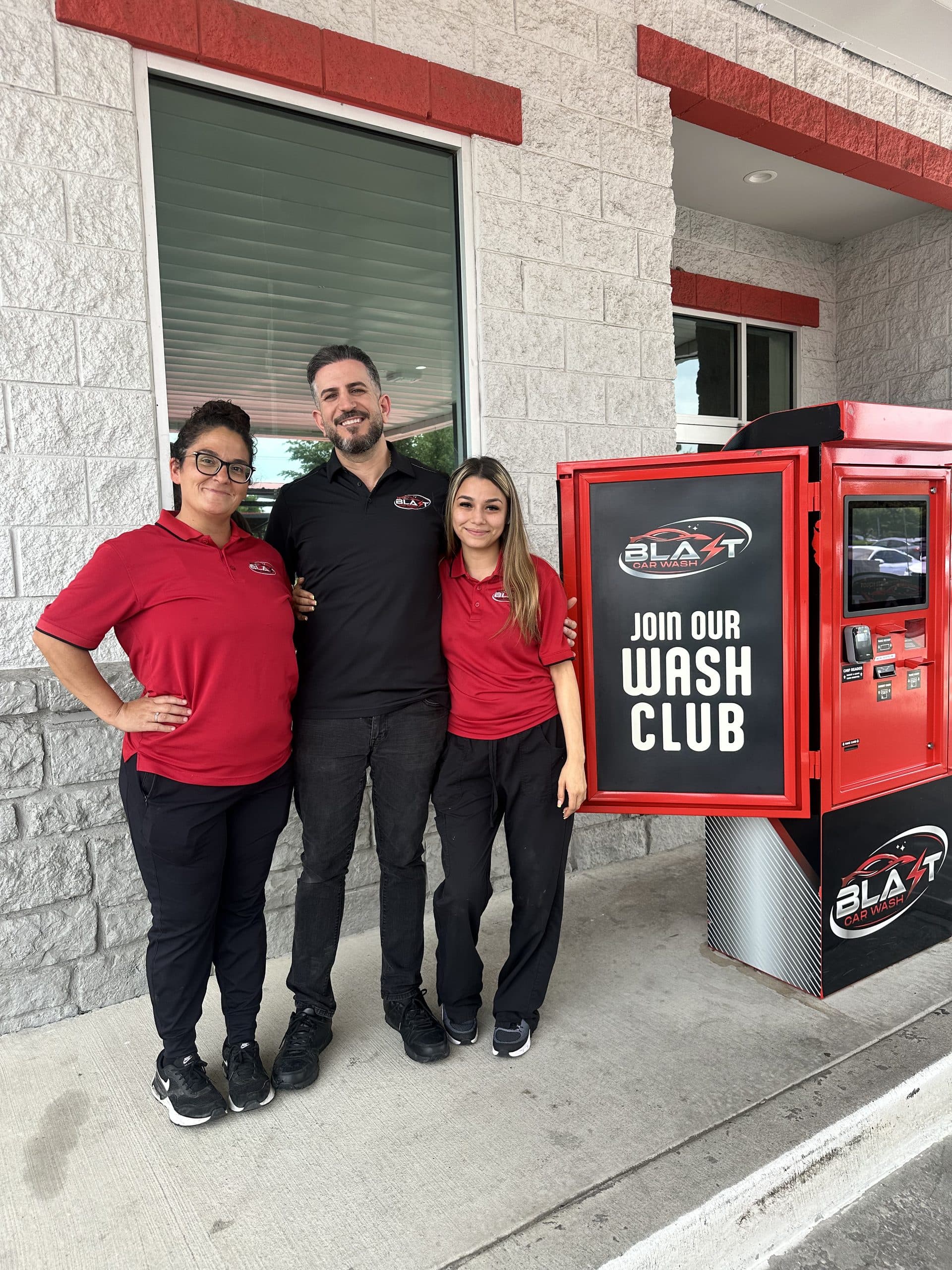 Blast team members at the Join Our Wash Club kiosk