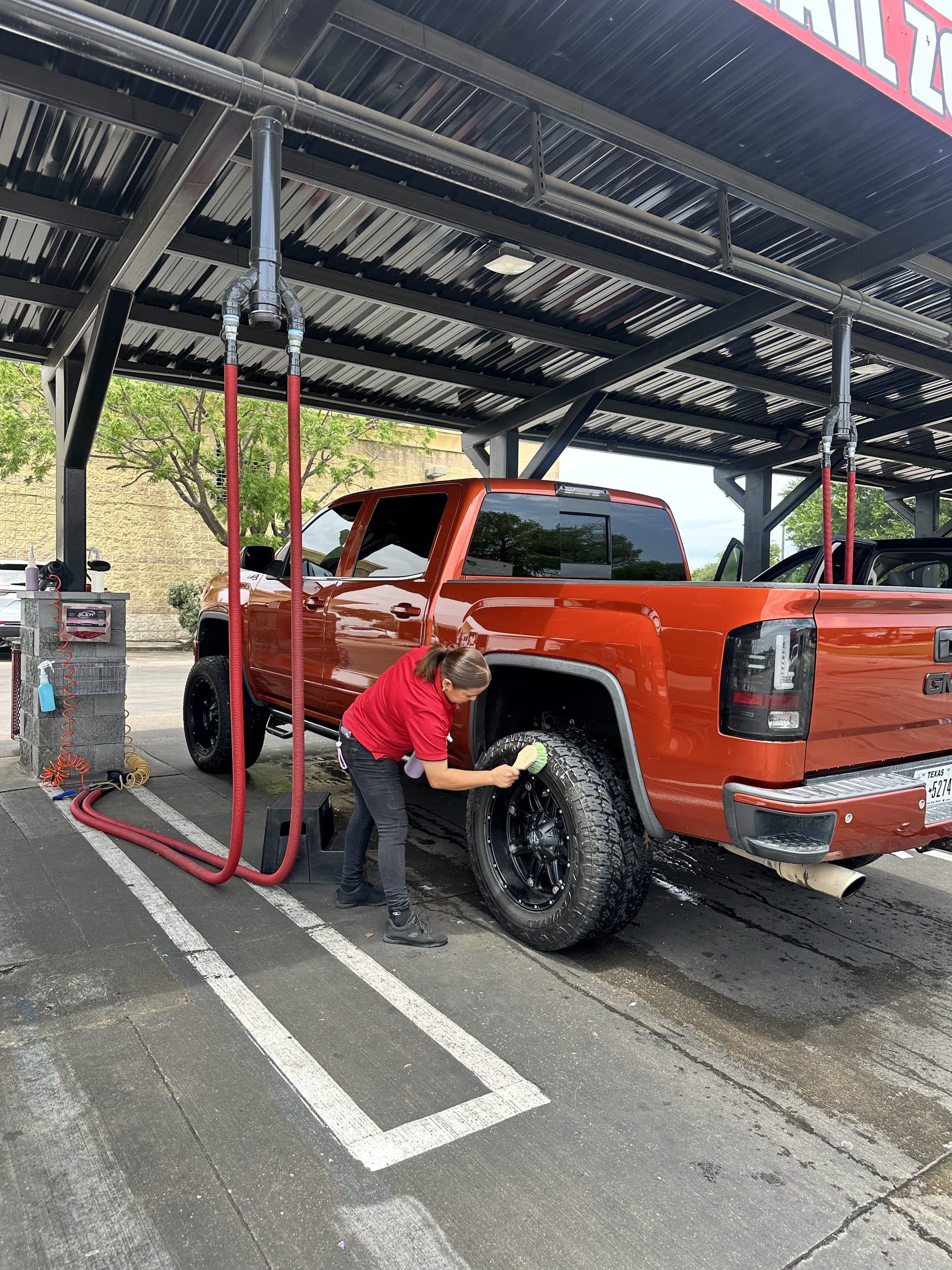 Detailing the wheels of a lifted GMC pickup
